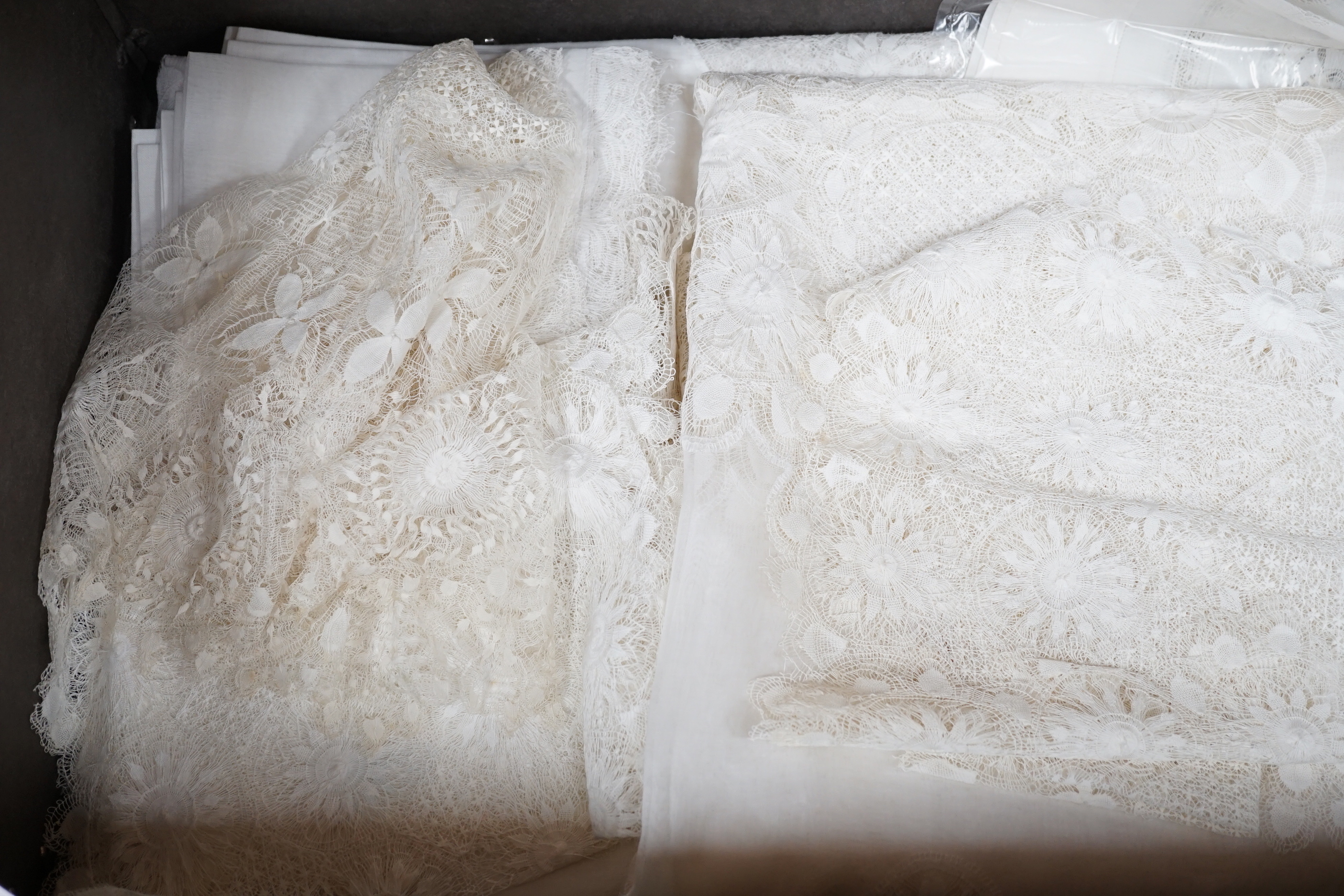 A collection of hand made finely worked tatting lace table linen, including cloths mats and napkins
